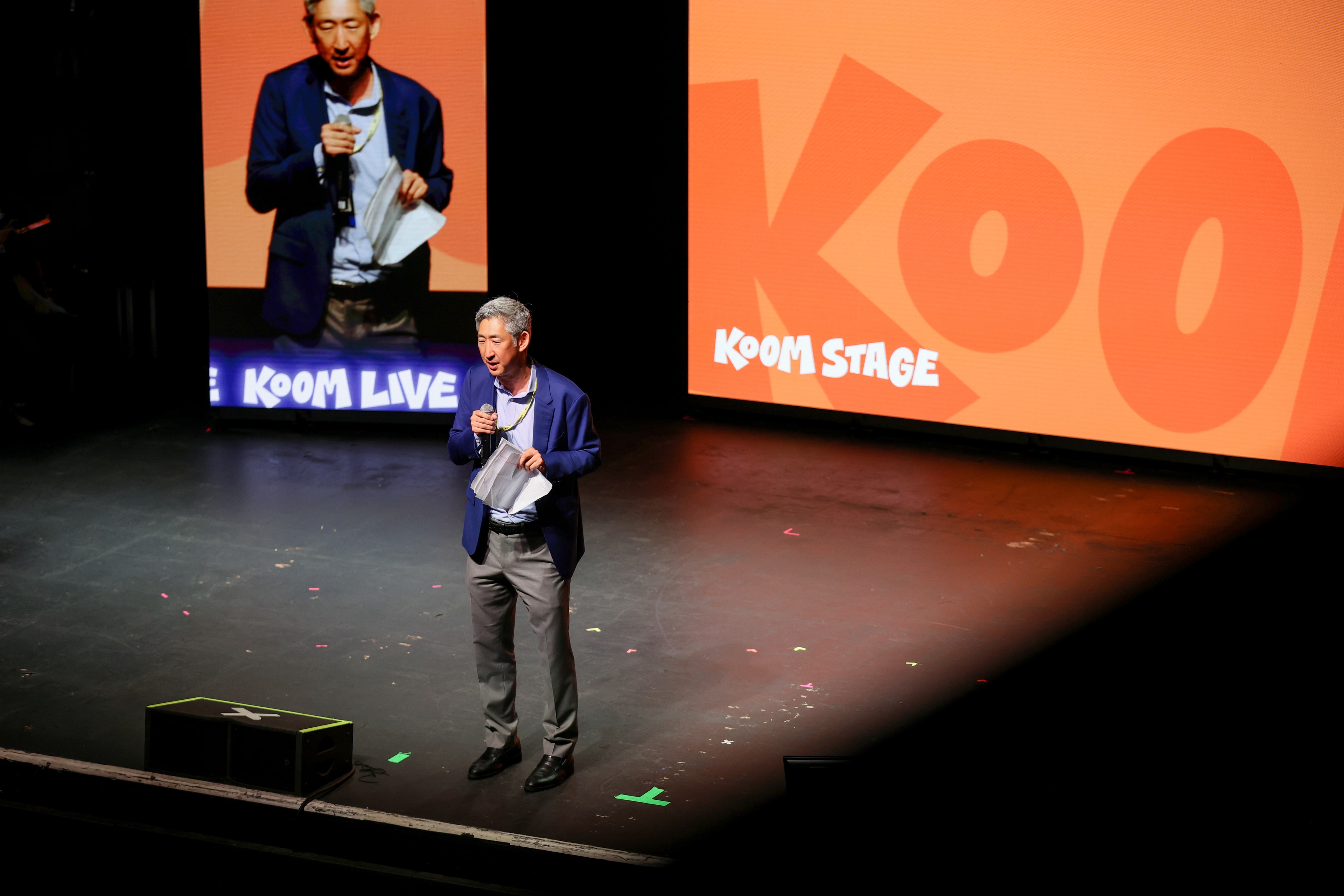 A speaker on the KOOM Stage
