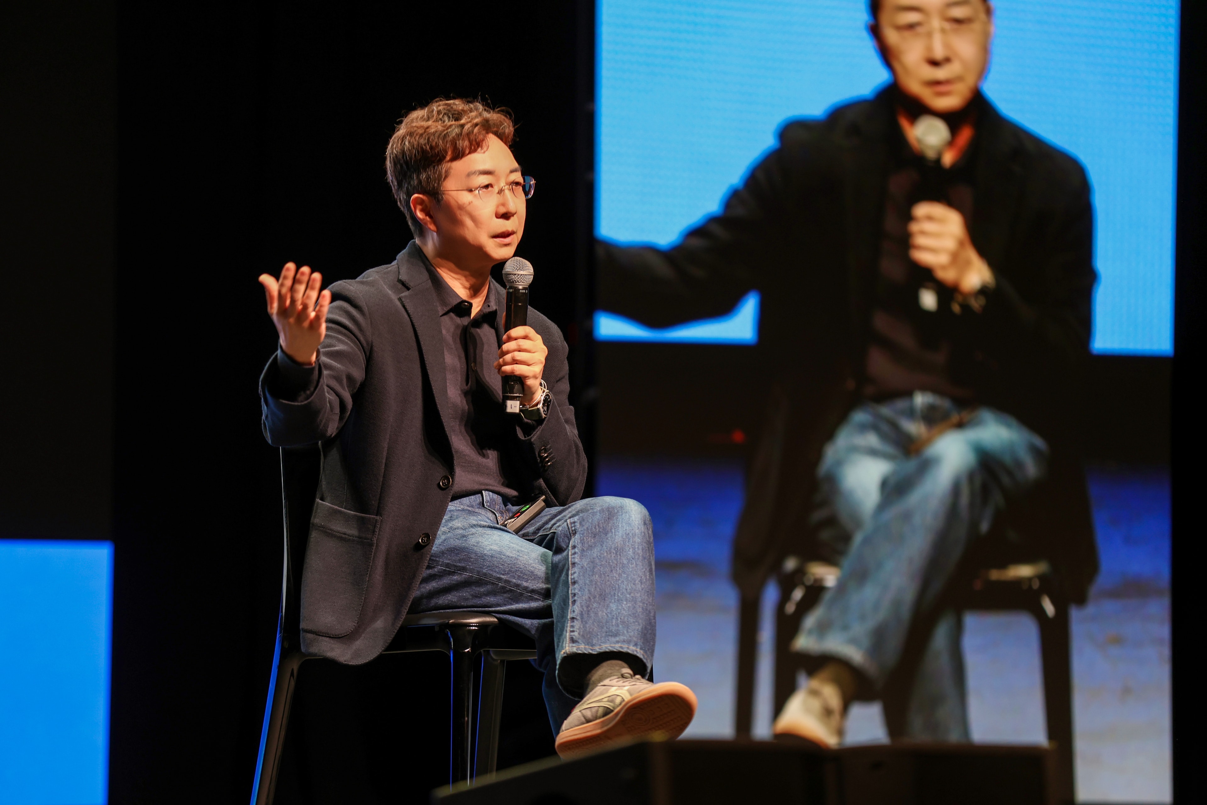 A speaker seated on the KOOM Stage